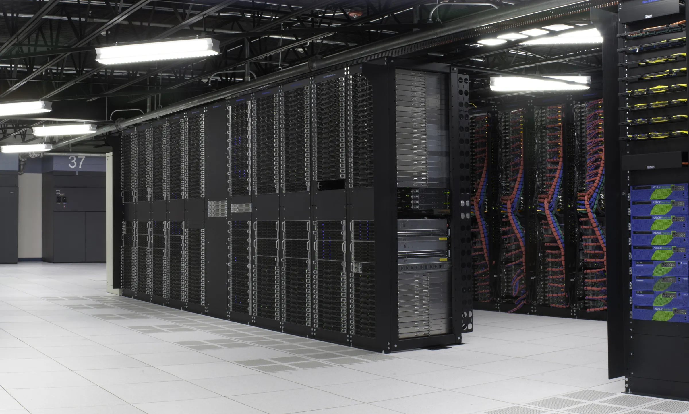 Rows of server racks in a data center hall